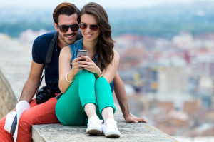 traveling couple using mobile phone
